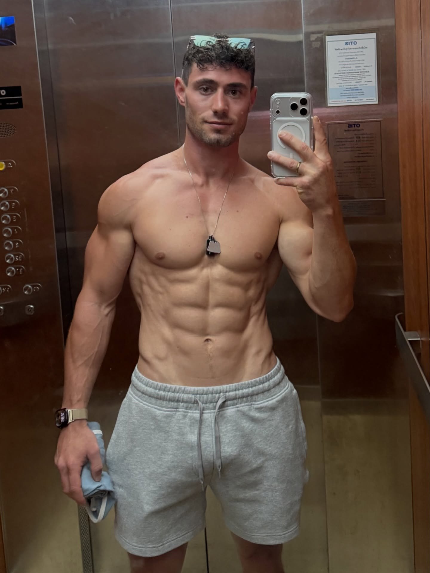 Josh Vasconcelos flexing in a gym mirror shot