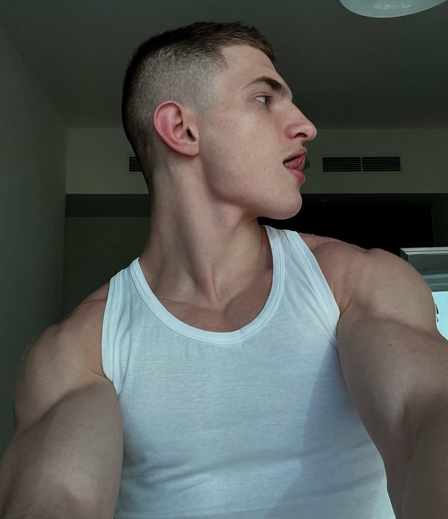Oleg Ravv posing shirtless in the gym after a workout